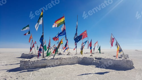 Preview: A large number of flags are spread out on a sandy beach