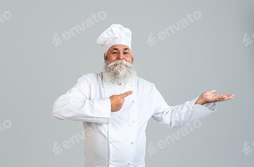 Preview: Senior old man cooking chef with gray beard portrait in studio