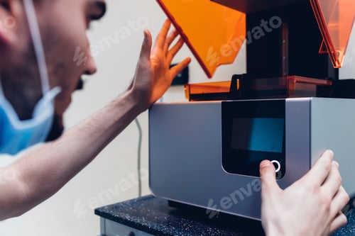 Preview: Male dentist using 3D printer