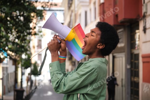 Preview: Young activist shouting with megaphone at LGBT pride parade