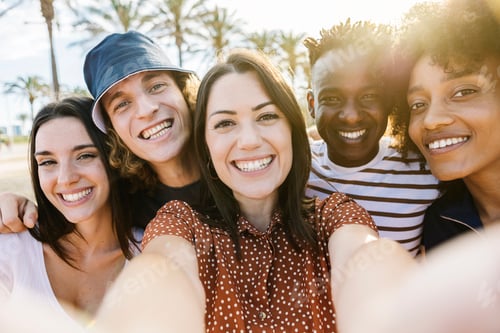 Preview: Group of happy multiracial people taking a selfie with phone