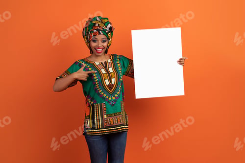 Preview: Excited traditional african woman holding white blank placard