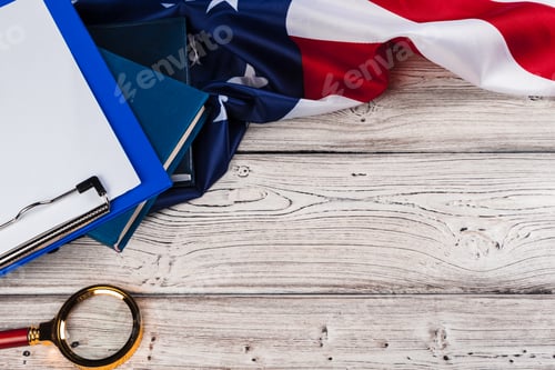 Preview: blank clip board and USA flag on wooden background