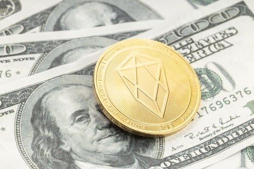 Preview: EOS coin on dollar banknotes