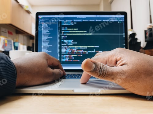 Preview: African American man using computer, computer code displayed on screen, programming, nerd culture