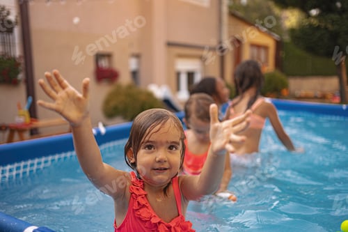 Preview: Children enjoying a sunny day playing in an inflatable pool