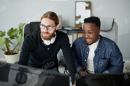 Preview: Small group of diversity programmers working in front of computer monitors
