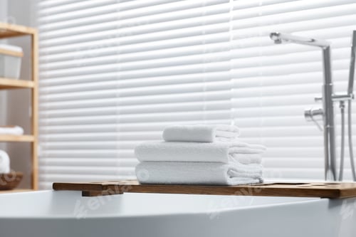 Preview: Stacked bath towels on tub tray in bathroom