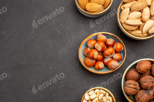 Preview: top view nut composition fresh nuts inside pots on dark background plant tree nuts walnut