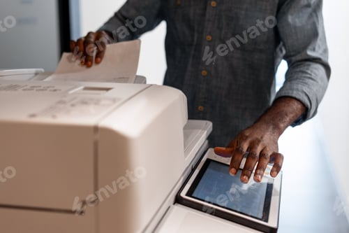 Preview: Office worker using a modern multifunction printer