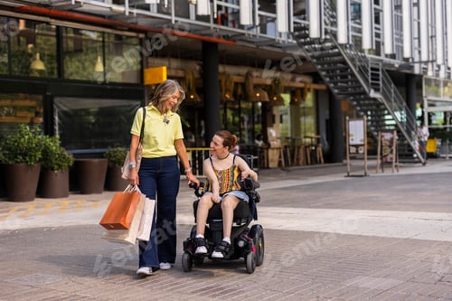 Preview: Woman pushing friend in electric wheelchair after shopping spree
