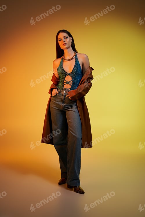 Preview: Beautiful young woman with trendy attire poses confidently against a colorful backdrop.