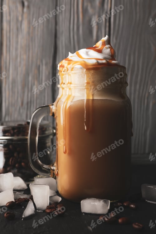Preview: Iced coffee with poured cream on gray wooden background