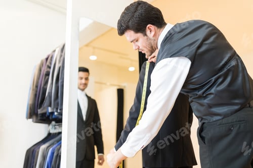 Preview: Tailor Examining Designer Suit At Shop