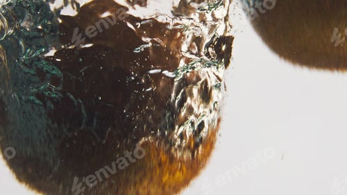 Preview: Closeup kiwis splashing water in bubbles. Sweet tropical fruits dropping liquid