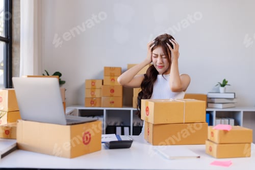 Preview: Stressed woman experiencing headache managing online e commerce business