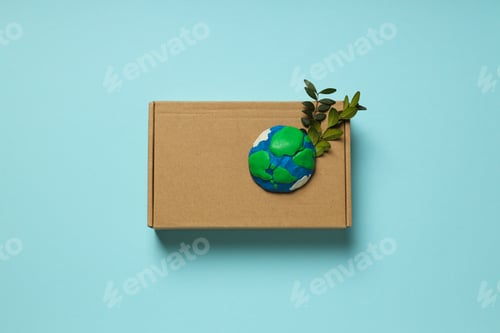 Preview: Earth on a Box with Green Plant Sprig