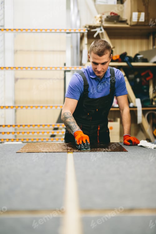 Preview: Glazier worker cleaning glass in workshop. Industry