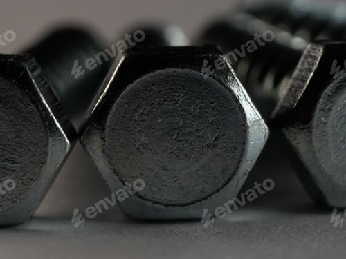 Preview: Closeup shot of lag screws on a gray surface