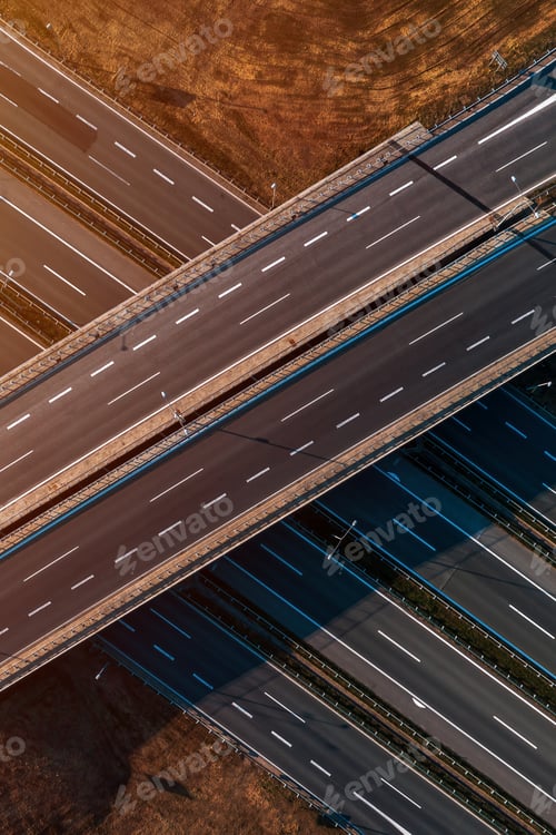 Preview: Aerial shot of empty freeway overpass with multiple lane highway asphalt road from drone pov