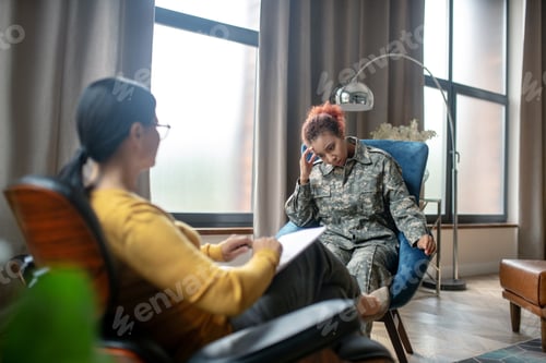 Preview: Servicewoman having headache while reminding tough moments