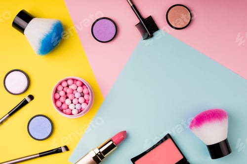 Preview: Makeup products and decorative cosmetics on color background flat lay. Fashion and beauty