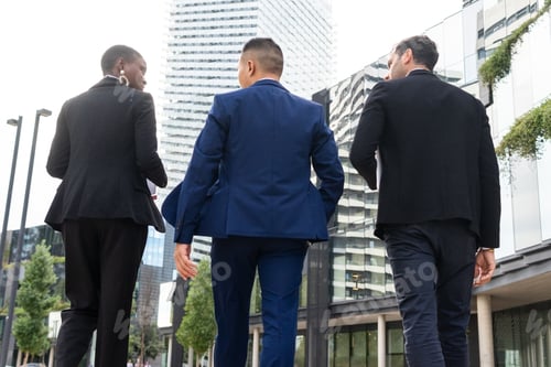 Preview: Anonymous multiethnic colleagues walking on the street