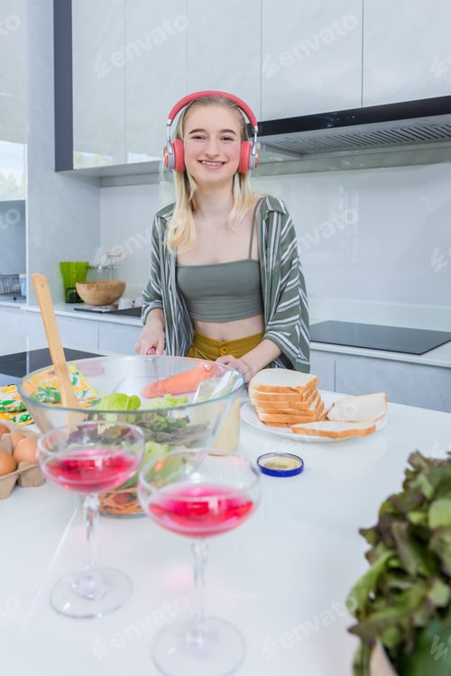 Preview: Girl at the kitchen Happy face. Preparing family dinner at home.