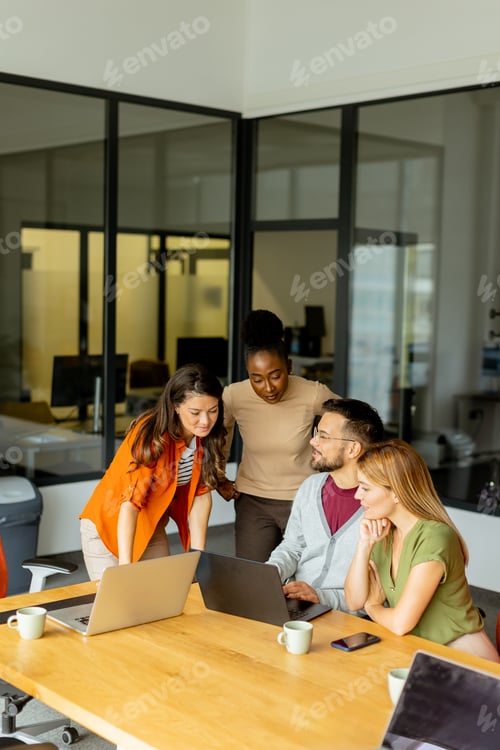Preview: Young multiethnic startup team working in the modern office