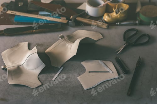 Preview: leather sheets for shoes on workplace at shoemaker shop