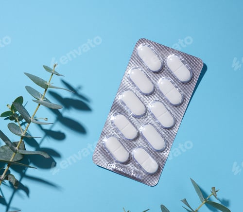 Preview: Oval white pills in a gray blister pack on a blue background
