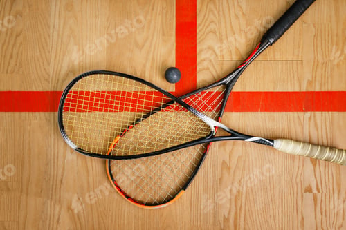 Preview: Squash rackets and ball on court floor, top view