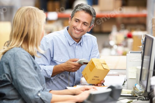 Preview: Business Colleagues Working At Desk In Warehouse