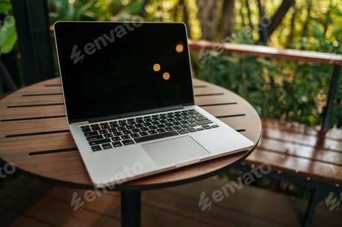 Preview: laptop on the table in the garden