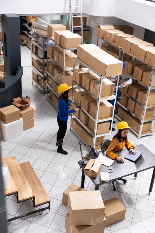 Preview: Female staff member sorting retail products in a small fulfillment center