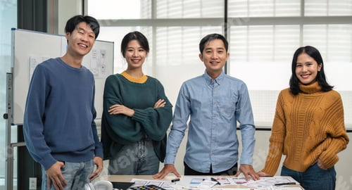 Preview: Successful Web developer team. Group of young modern people in casual wear using modern