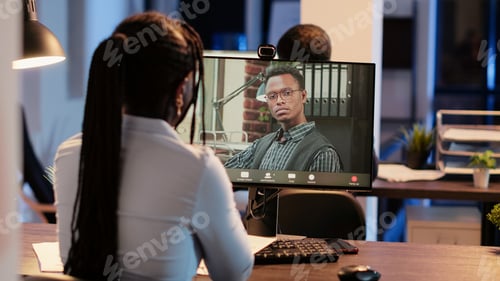 Preview: Business woman attending videocall online meeting with man