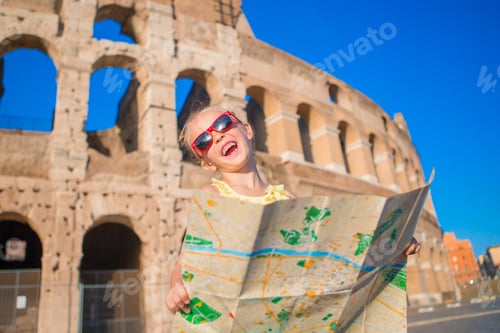 Preview: Adorable little active girl with map in front of Colosseum in Rome, Italy. Kid spending childhood in