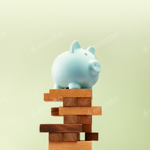 Preview: Piggy bank stands on precariously Jenga blocks, symbolizing fragile financial stability