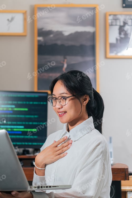 Preview: Smiling Woman Working on Laptop in Home Office