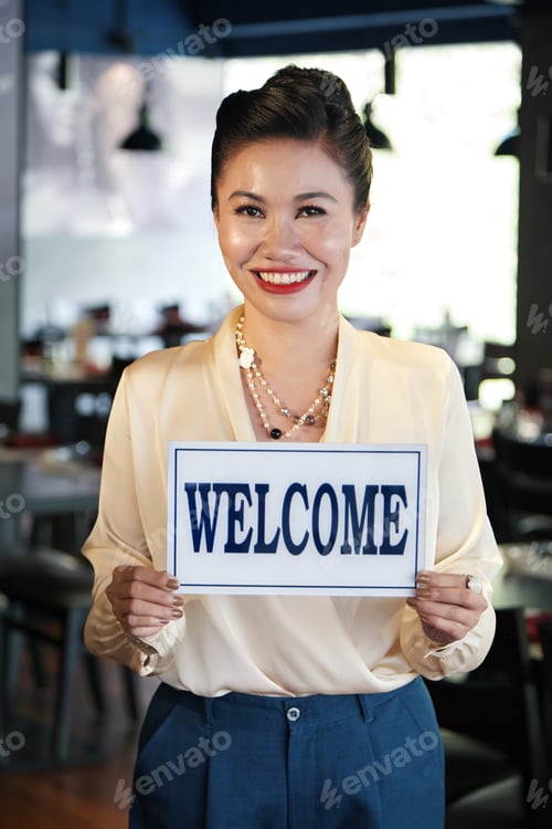 Preview: Restaurant Owner holding Welcome Sign