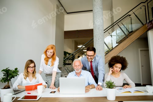 Preview: Joyful multiracial business team at work in modern office