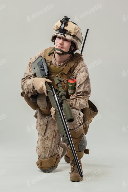 Preview: Soldier on knee holding rifle with focus during tactical drill in training setting