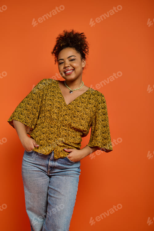 Preview: Radiant Queen: African American Woman Stands Before Orange Canvas