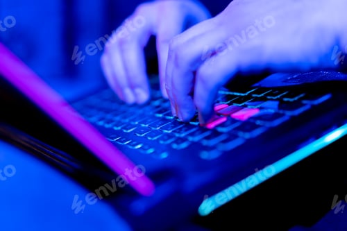 Preview: close-up of hands of hacker pressing keys on keyboard in data center vulnerable cyber security