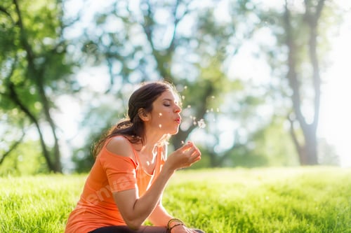 Preview: Portrait of a girl in nature blowing a dandelion