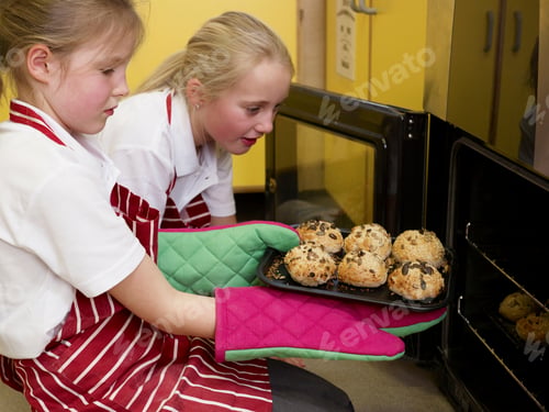 Preview: girls taking bread out of the oven