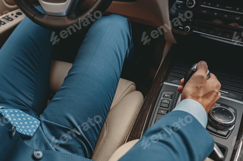 Preview: Man putting hand on automatic transmission of car