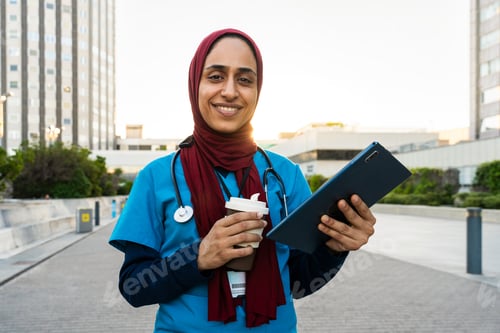 Preview: Beautiful arab nurse wearing hijab portrait in the city