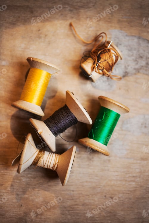 Preview: Bobbins of wound thread, silks and cottons in bright colours.